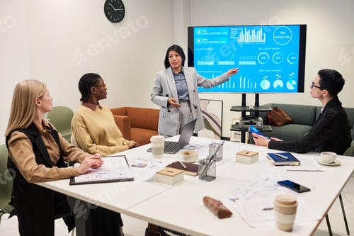 Preview: Young Multiethnic Businesswomen Presenting Data Analysis during Office Meeting