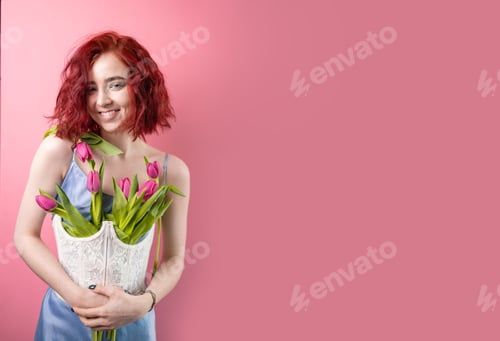 Preview: Portrait of a beautiful young red head girl holding a bouquet of irises and tulips isolated on a pin