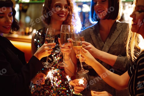 Preview: Three young Woman with champagne glasses at night club. Women friends drinking champagne in the bar.