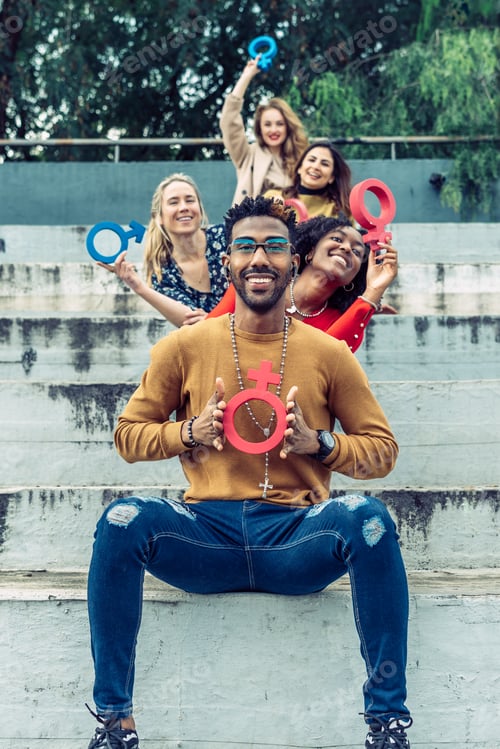 Preview: a smiling black man shows an upside-down feminist symbol to the camera