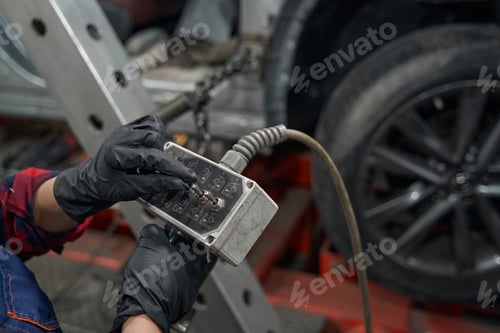 Preview: Auto mechanic using diagnostic equipment in care repair garage