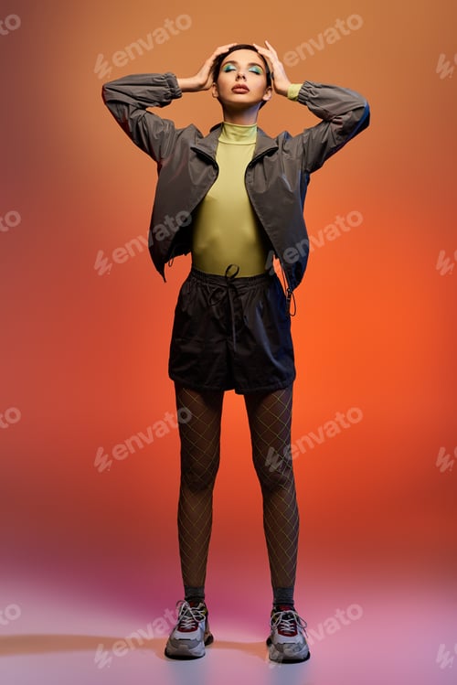 Preview: Confident young woman poses in a trendy outfit with a vibrant gradient backdrop