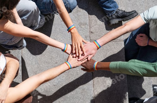 Preview: Activists joining hands showing rainbow bracelets: celebrating lgbtq pride and equality