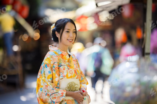 Preview: Asian woman try to wear Japanese kimono with the traditional Japanese village background