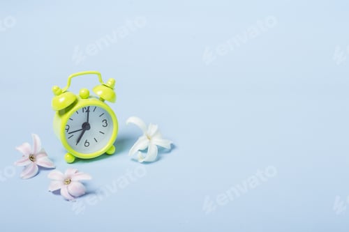 Preview: Spring Flowers and alarm clock. Springtime concept