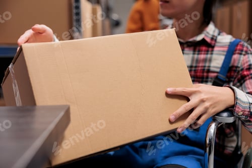 Preview: Postal service worker with disability holding package