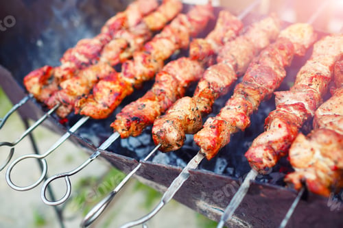 Preview: appetizing pieces of roasted meat on the fire