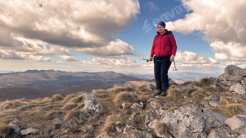 Preview: Senior woman on the mountain ridge