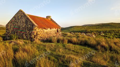 Preview: Beautiful landscape scenery with old rusty tin roof cottage on green hill at Connemara National par