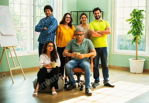 Preview: Confident Indian Asian business team in casuals, smiling, celebrating success in modern workspace