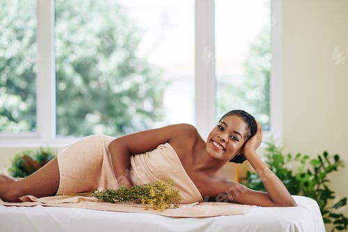Preview: Young Black woman wrapped in towel