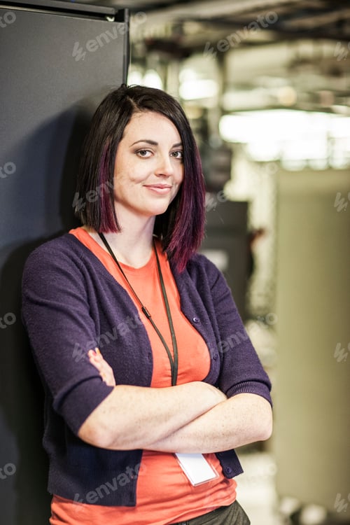 Preview: Caucasian woman technician in a large computer server farm.