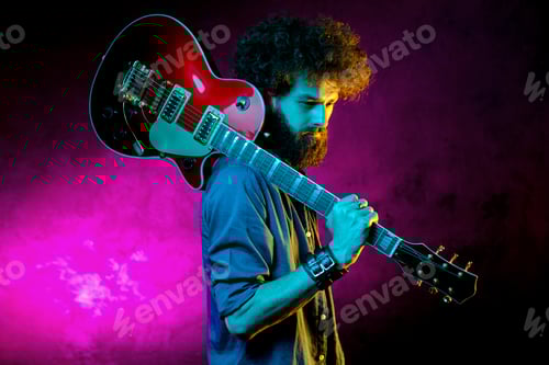 Preview: Musician With a Guitar on Shoulder in Studio