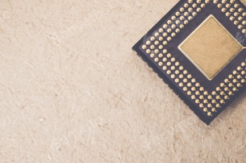 Preview: Top view closeup of a black round box with gold beads on it on a toned rough stone textured surface
