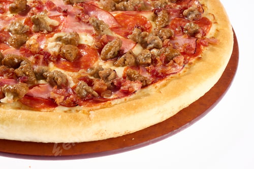 Preview: Delicious pizza loaded with a variety of meats, including pepperoni, sausage, and ham.