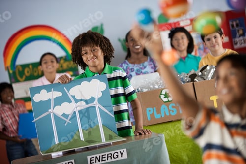 Preview: A class of children at a Green Science Fair event, with presentations on solar power and recycling.