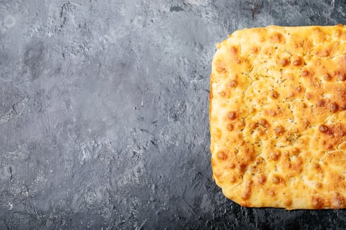 Preview: Baked focaccia bread served with olives