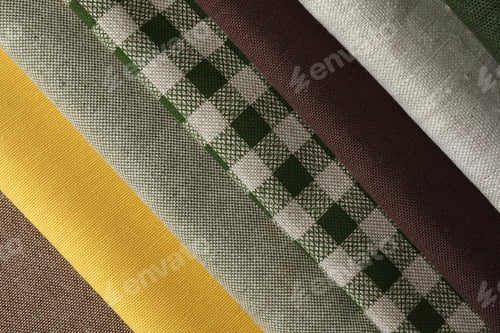 Preview: Many different fabrics on brown cloth, closeup