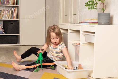 Preview: Child playing on the floor in dinosaurs in the room