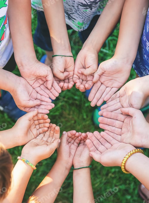 Preview: The children put their hands together. Selective focus.