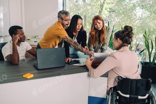 Preview: Inclusive coworkers gather in boardroom exchanging ideas at briefing