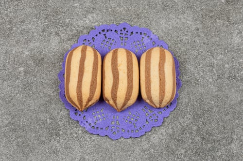 Preview: Delicious chocolate striped biscuits on blue napkin