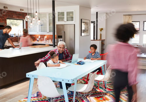 Preview: Children Doing Homework In Busy Multi Generation Family Home
