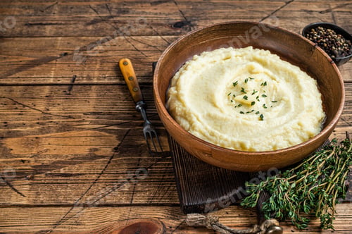 Preview: Mashed potatoes, boiled puree in a wooden plate. Wooden background. Top view. Copy space