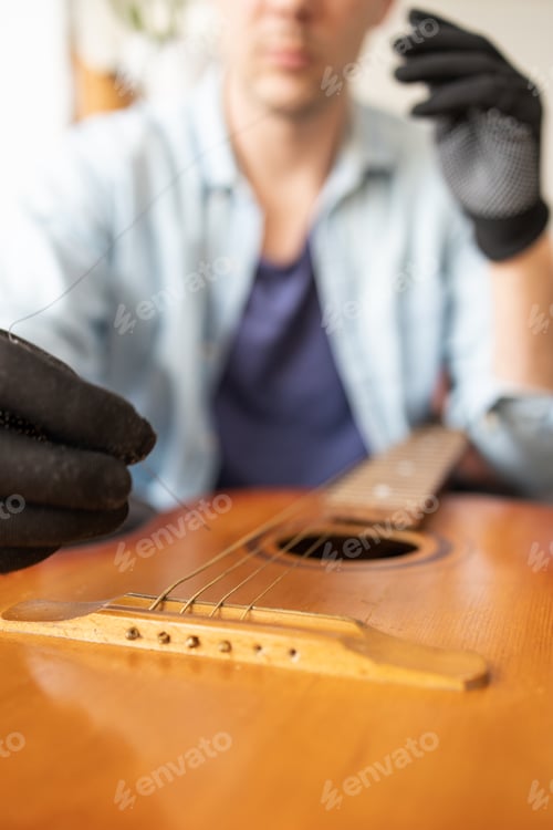 Preview: the technician setting up the guitar in the workshop