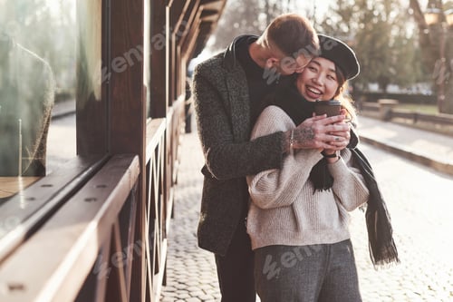 Preview: Playful and lovely multiracial couple together outdoors in the city
