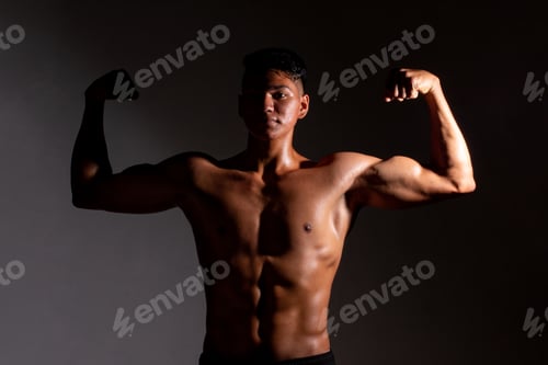 Preview: Slim and muscular young man posing with his naked torso. Man starting his muscle growth stage.