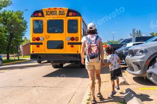 Preview: Mother walking child to school bus on first day back to school