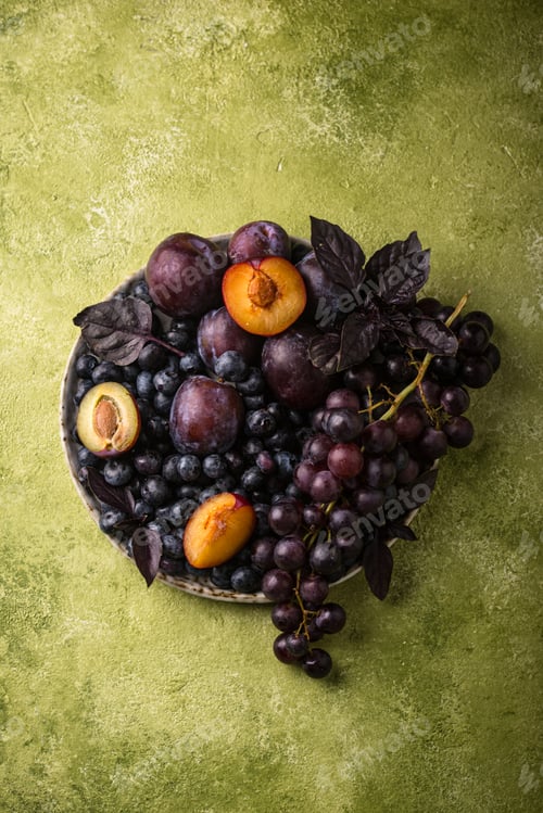 Preview: Assortment of purple fruit plum, grape, blueberry and basil