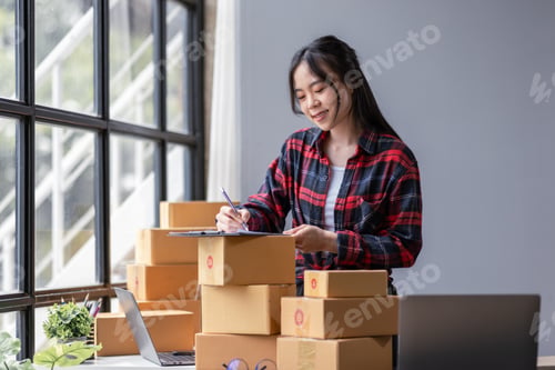 Preview: Startup happy Asian woman sme business owner work with prepare parcel delivery boxs at home, SME sup