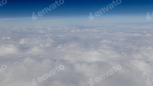 Preview: The beautiful cloudscape with clear blue sky. A view from airplane window.