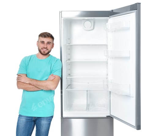 Preview: Young man near empty refrigerator on white background