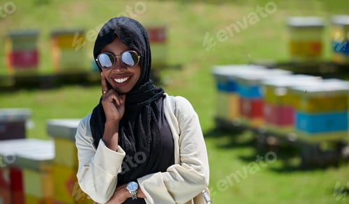 Preview: african muslim businesswoman portrait on small local honey production farm