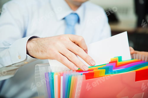 Preview: Office worker filing document