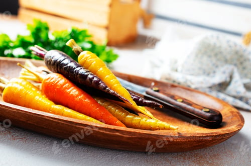 Preview: A bunch of carrots of different colors on a gray background.