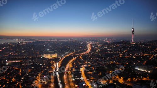 Preview: City skyline at sunset with lights and tall tower visible in istanbul
