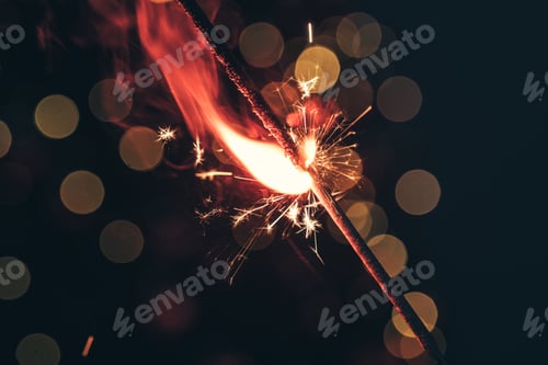 Preview: Red bengal sparkle lights close up on dark background