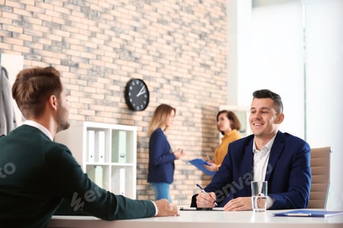 Preview: Human resources manager conducting job interview with applicant in office