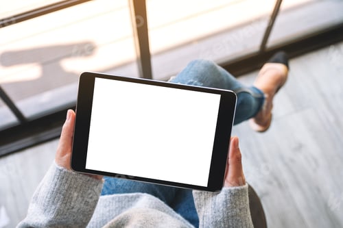 Preview: Top view mockup image of a woman holding black tablet pc with blank white screen