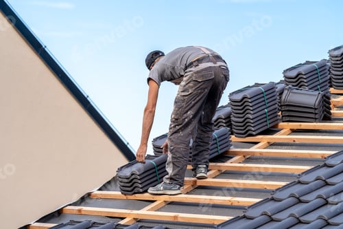 Preview: new roof of a family house, a roofer builds a roof made of ceramic tiles