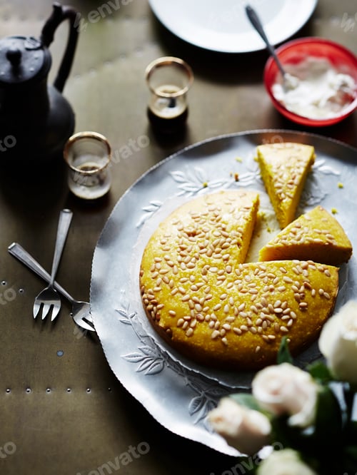 Preview: Sliced cake with sesame seeds on a decorative plate