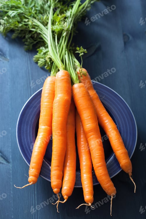 Preview: fresh carrot over blue background