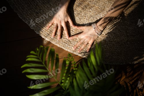 Preview: Hands of a woman doing yoga at home.