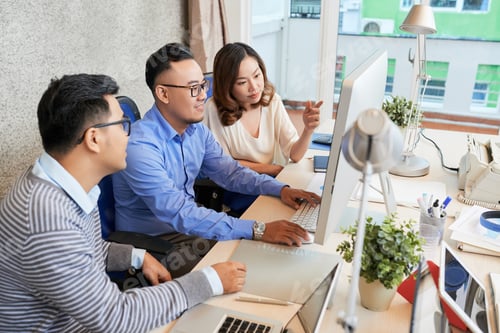 Preview: Coworking team of ethnic colleagues using computer
