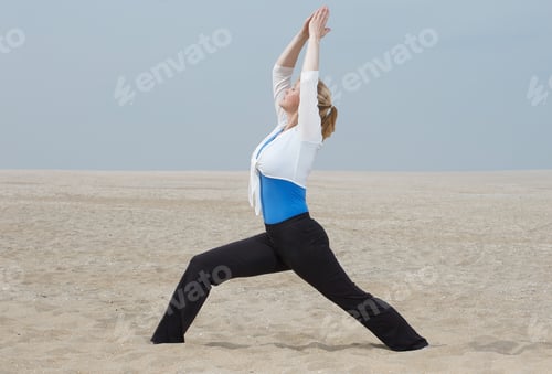 Preview: woman standing in yoga pose at beach