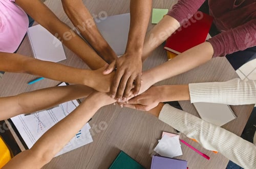 Preview: International college students stacking their hands together